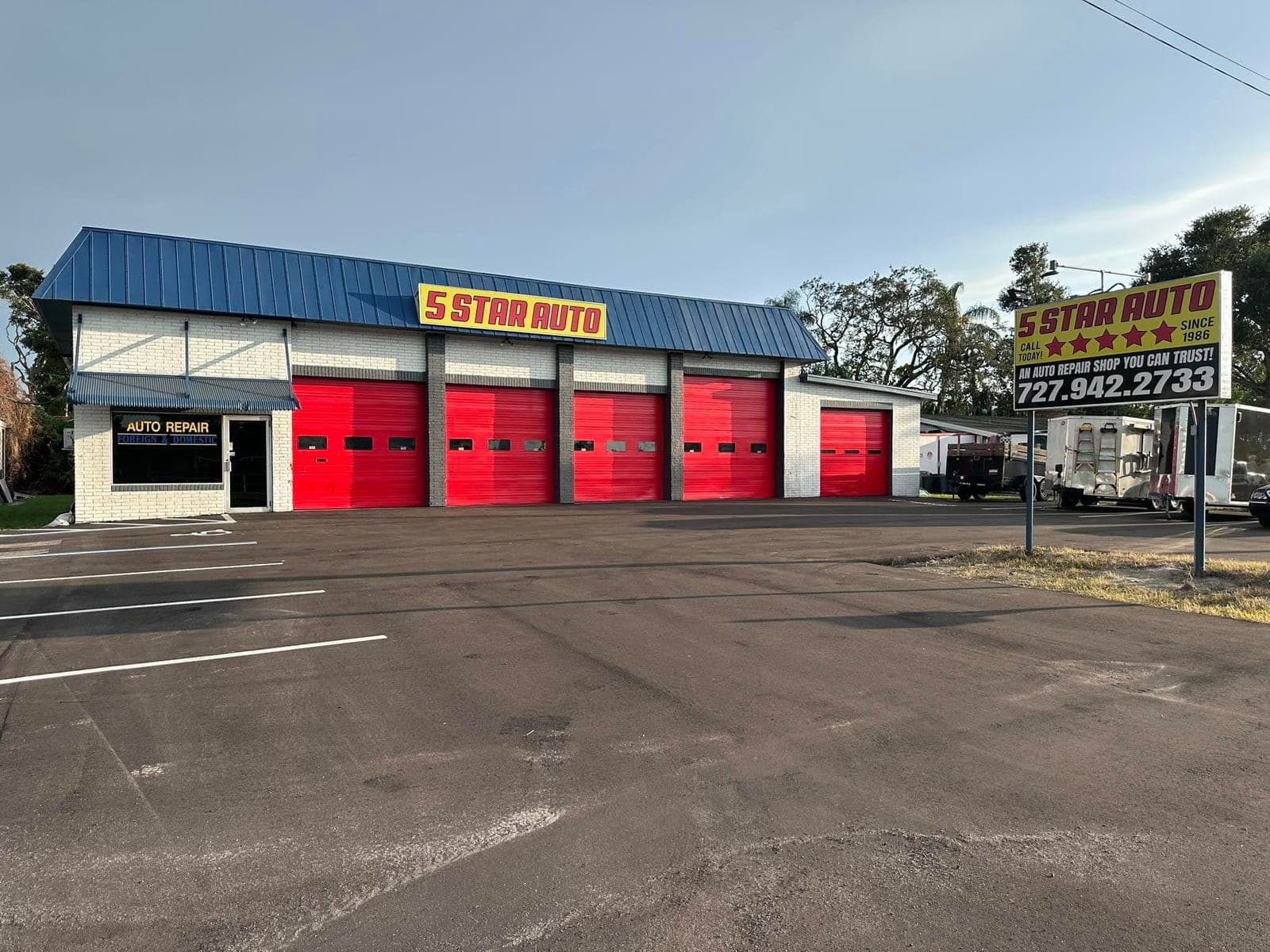 Five Star Auto Repair Holiday FL shop — yellow 5 STAR AUTO sign, red bays, and roadside sign with 727-942-2733.